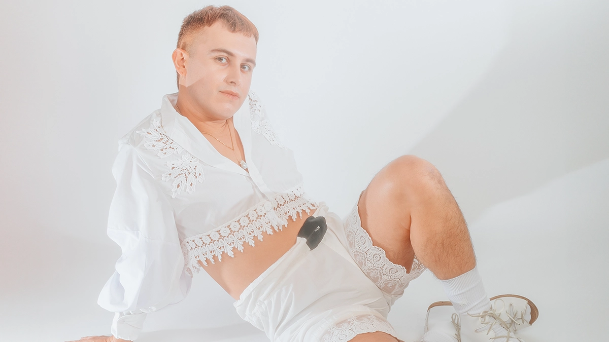 Felix III in white shorts and crop top - white background - sitting on the floor