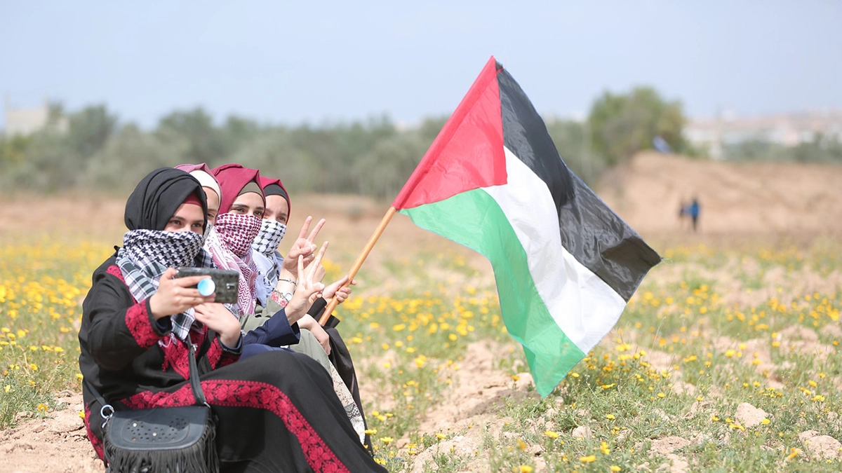 3 persons with the Palestine flag